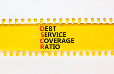 DSCR debt service coverage ratio symbol. Concept words DSCR debt service coverage ratio on yellow paper on beautiful white background. Business DSCR debt service coverage ratio concept. Copy space.