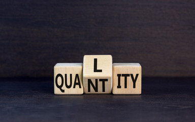 Quality and quantity symbol. Concept word Quality Quantity on wooden cubes. Beautiful black table...
