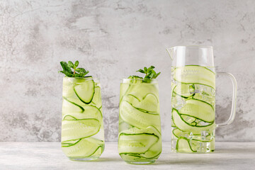 Fresh infused cucumber water on a light background