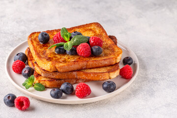 French toast with blueberries, raspberries, maple syrup