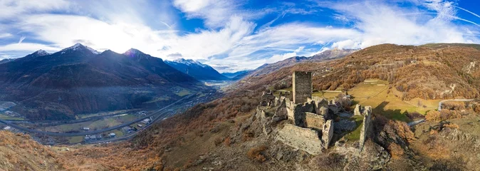 Poster Medieval impressive castle Cly surrouded by Alps mountains in Valle d'aosta, Italy. aerial drone panoramic view © Freesurf