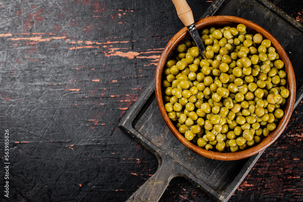 Canvas Prints Canned green peas in a wooden bowl. 