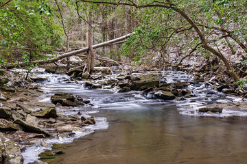 A clear mountain stream with cascading water falls a winter scene with snow and ice. The Fiery...