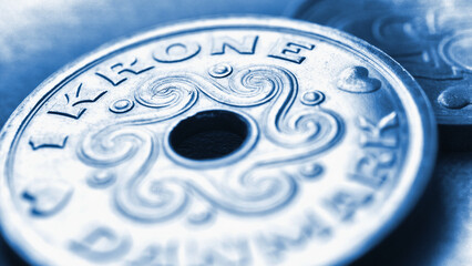 1 one Danish krone coin close up. National currency of Denmark. Blue tinted money illustration for news about economy or finance. Banking and credit. Wages and taxes. Macro