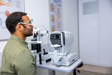 Dark-haired man having a n appointment at the optometrist office