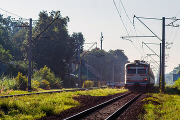 Naklejka premium Suburban passenger trains is moving along the railroad. Selective focus.