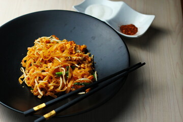 Fried Thai Noodle with Pad Thai and Vegetable, Put on Wooden Table