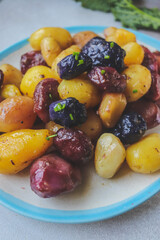 fried colored potatoes appetizing close-up on a clay plate 