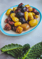 fried colored potatoes appetizing close-up on a clay plate 