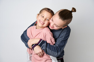 Boy and girl hugging each other on white background