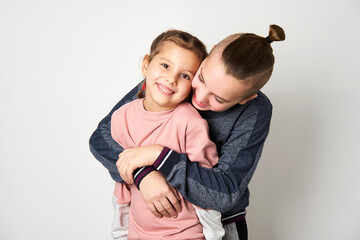 Boy and girl hugging each other on white background
