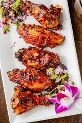 
Chicken wings. Buffalo chicken wings. American cuisine of chicken wings deep-fried, dipped in buffalo sauce made of vinegar,  cayenne hot sauce and butter. Served with celery, carrots, blue cheese.