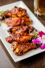 
Chicken wings. Buffalo chicken wings. American cuisine of chicken wings deep-fried, dipped in buffalo sauce made of vinegar,  cayenne hot sauce and butter. Served with celery, carrots, blue cheese.