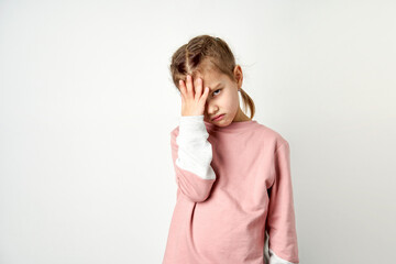 Cute child girl tired having headache, white background