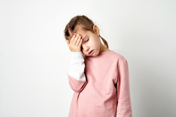 Cute child girl tired having headache, white background - 563994818
