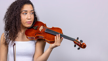 Classical music concept. Copyspace. Disappointed young girl with her violin on her shoulder.