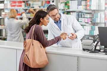 Medicine, help and pharmacist advice with side effects at health store counter for customer service. Pharmaceutical advice and opinion of worker helping girl with medication information at pharmacy. - obrazy, fototapety, plakaty