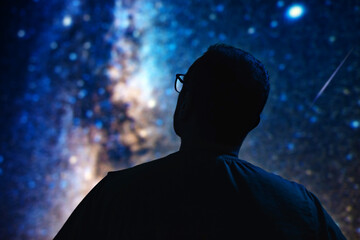 Silhouette of a man with Milky Way starry skies.