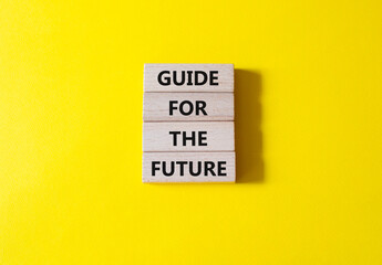 Guide for the future symbol. Wooden blocks with words Guide for the future. Beautiful yellow background. Business and Guide for the future concept. Copy space.