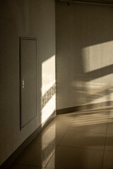 You can see the light and door at the end of the hall, A water meter's door at the hallway of building