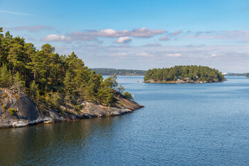 Stockholm Archipelago, view from the cruise ship. Rocks with trees.