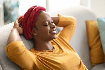Closeup of happy african american woman chilling at home