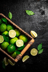 Lime with leaves in a basket. 