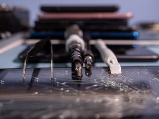 Old broken smartphone and repair tool. The concept of computer equipment, mobile phones,...