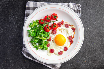 breakfast fried egg sausage, vegetable fresh meal snack on the table copy space food background rustic top view