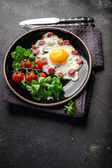 breakfast fried egg sausage, vegetable fresh meal snack on the table copy space food background rustic top view