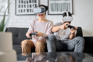 VR, gaming and metaverse with a couple playing video games in their home together for fun or...