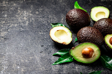 Pieces of fresh avocado with leaves. 