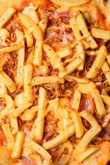 Close-up top view of pizza topping. Pizza with french fries and bacon