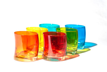 Multicoloured drink glasses isolated on white background.