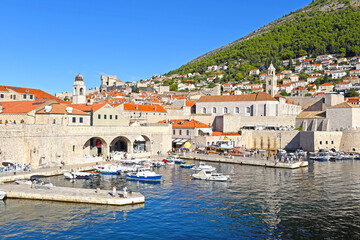Fototapeta na wymiar Dubrovnik harbor and city walls morning view with calm sea, Dalmatia region of Croatia