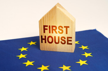 On the flag of the European Union there is a model of a wooden house with the inscription - FIRST HOUSE