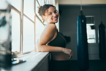 Portrait, window and woman with smile, fitness and workout for wellness, healthy lifestyle or...