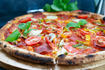 Pizza with salami and tomatoes