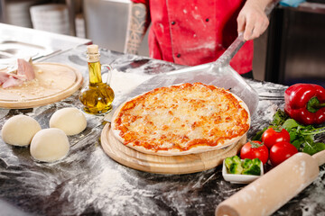 pizzaiolo prepares pizza in the kitchen, the chef prepares the dough