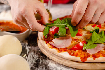 pizzaiolo prepares pizza in the kitchen, the chef prepares the dough