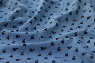 Wavy blue fabric with flamingo picture. © megaflopp