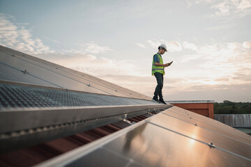 Service engineer checking solar cell on the roof for maintenance if there is a damaged part. Engineer worker install solar panel. Clean energy concept.