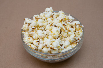 Glass bowl full of homemade popcorn on the table