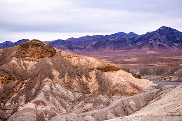 Zabriskie Point. It is a part of the Amargosa Range located east of Death Valley National Park in California, United States. One Man on the Top of Mountain.
