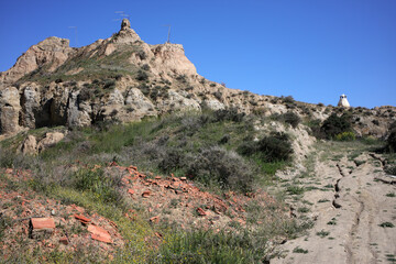 Fototapeta premium Barrio de Santiago - troglodyte houses carved in tuff rocks - Guadix - Andalusia - Spain