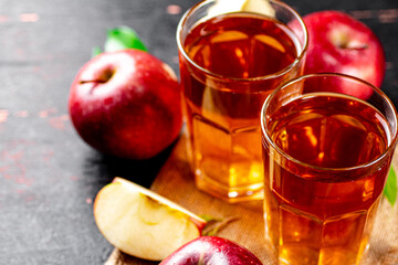 Fresh apple juice. Against a dark background.