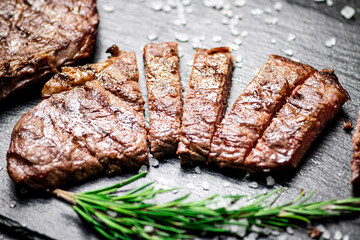 Grilled steak with a sprig of rosemary. 