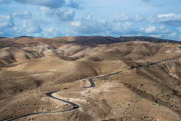 Landscape of Israel desert. Blue Cloudy Sky and road in background. Mountain. Judaean Desert