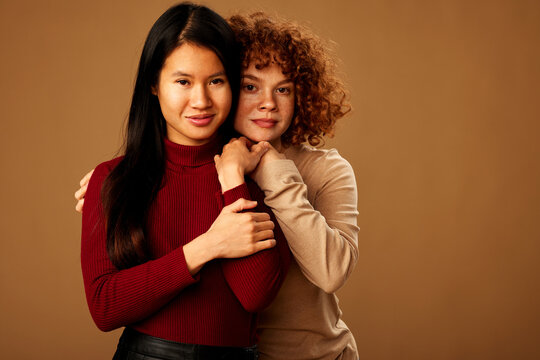 Diversity. A multiracial girls hugging and posing in studio.