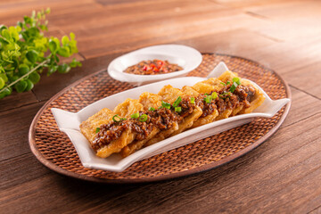 Golden Eggplant with Minced Meat and garlic sauce served dish isolated on wooden table top view of Hong Kong food